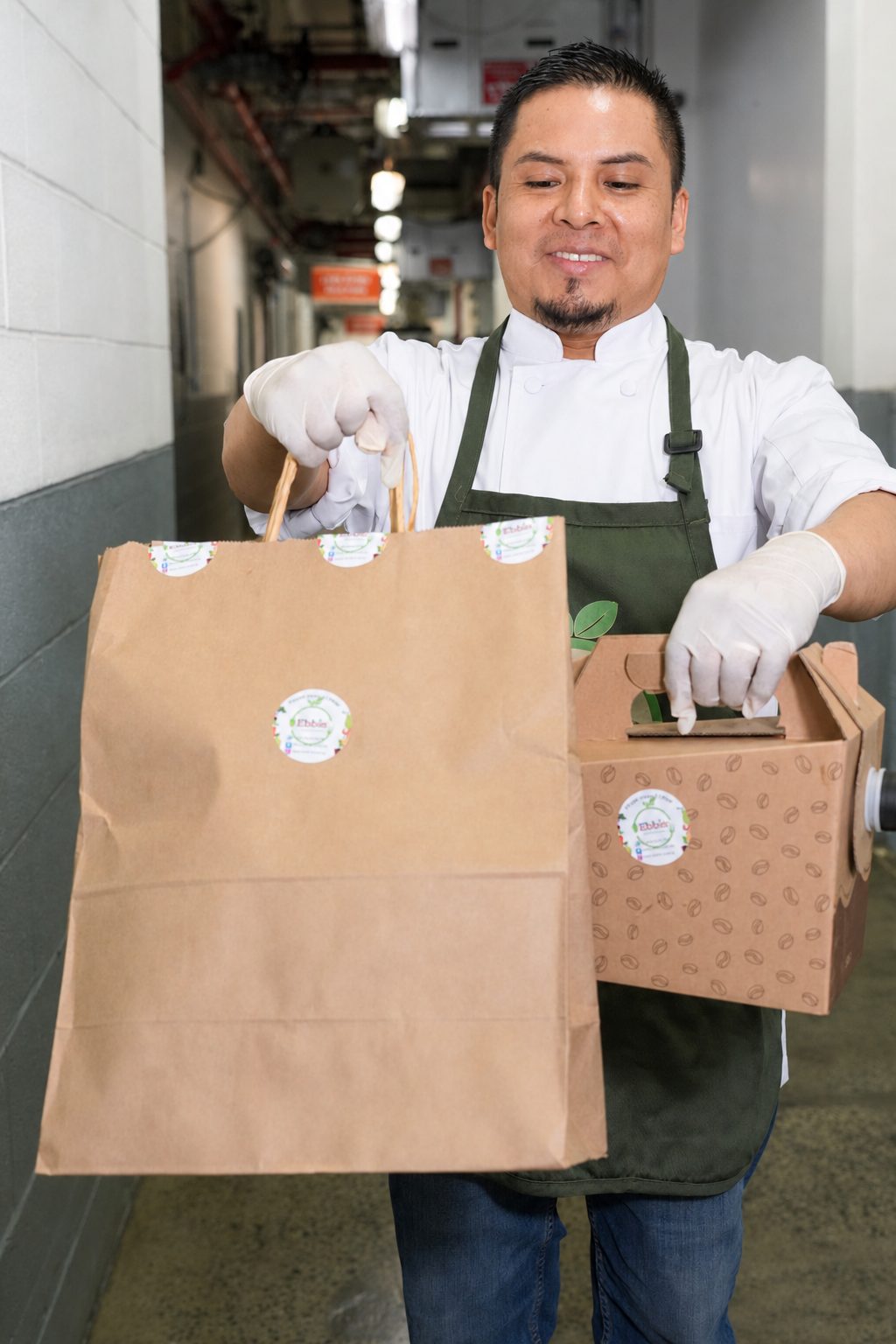 Ebbie chef handing over packed orders